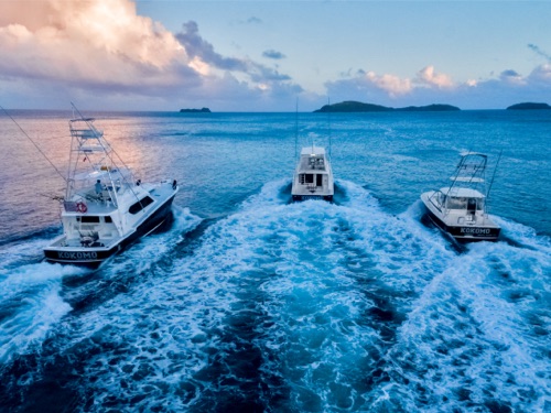 The fishing boat ‘Twilight’ out on the water at sunset, off the coast of Kokomo Private Island Fiji.